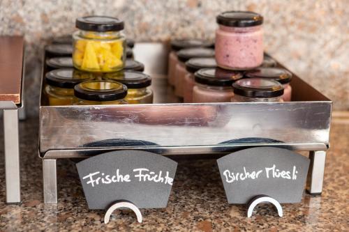 a kitchen counter with a stove top with some spices at Schönbühl Hotel & Restaurant Lake Thun in Thun