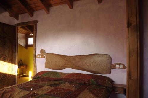 a bedroom with a bed with a wooden head board at O´Porron in Sabiñánigo