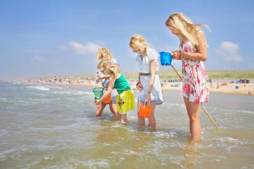 a group of girls standing in the water at the beach at Stayokay Hostel Haarlem in Haarlem