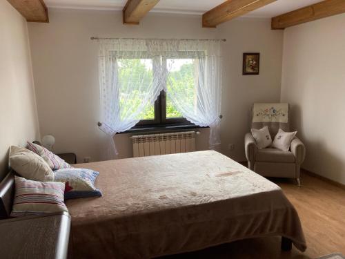 A bed or beds in a room at Kornatka Hajnówka Pokoje Puszcza Białowieska