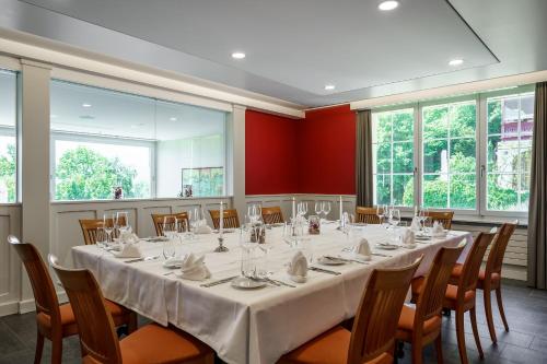 a conference room with a long table and chairs at Schönbühl Hotel & Restaurant Lake Thun in Thun