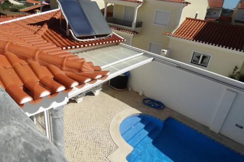 an overhead view of a roof of a house with a swimming pool at Mia's House in Casa Nova