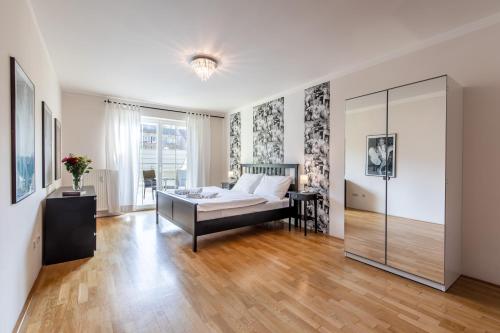 a bedroom with a bed and a glass wall at Rezidence Čertovka in Karlovy Vary
