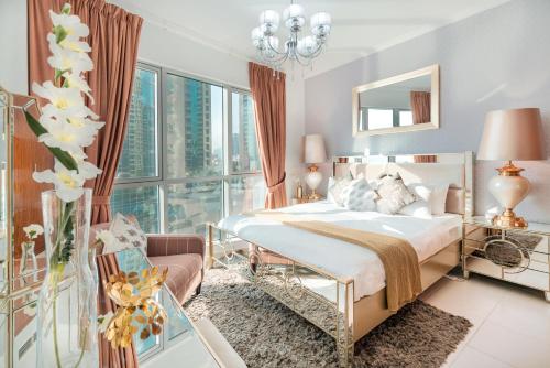 a bedroom with a bed and a large window at Elite Royal Apartment - Full Bujr Khalifa & Fountain View - Senator - 2 bedrooms & 1 open bedroom without partition in Dubai