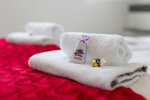 a pile of towels on a bed with a small toy at Villa Helines***** in Linardići
