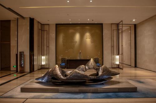 a lobby with a large sculpture in the middle at Crowne Plaza Hefei Rongqiao by IHG in Hefei
