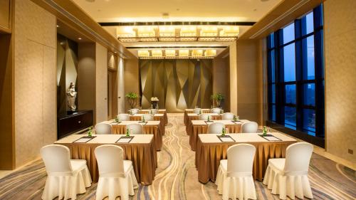 a conference room with tables and chairs and a large window at Crowne Plaza Hefei Rongqiao by IHG in Hefei