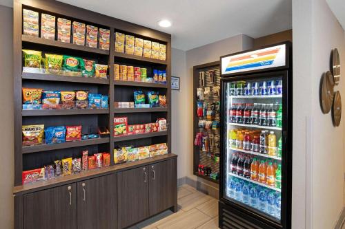 a grocery store aisle with a large refrigerator at La Quinta Inn & Suites by Wyndham Las Vegas Nellis in Las Vegas