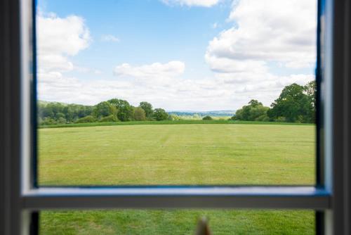 a view of a field from a window at Barrow Hill Barns in Petersfield