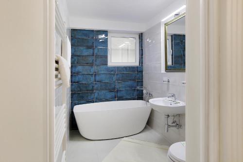 Un baño con inodoro, bañera y lavabo. en Excelsior Boutique Hotel Sinaia, en Sinaia