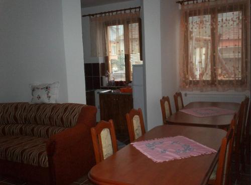 a living room with a couch and a table at Szikla Vendégház in Istenmezeje