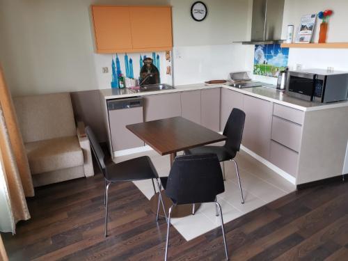 a kitchen with a table and chairs in a room at Foka, Sun & Snow in Hel