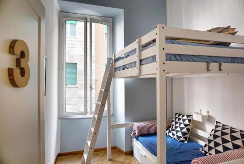 a bedroom with a bunk bed and a television at Grand Hostel Manin in La Spezia