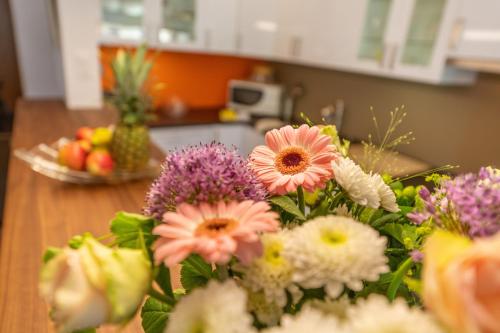 a bunch of flowers on a table in a kitchen at Haus Sonnheim in Zermatt