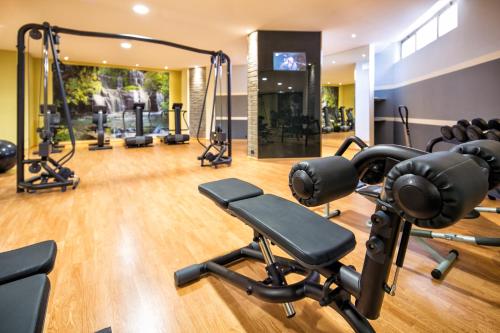 a gym with several treadmills and exercise bikes at Umbriaverde Sporting & Resort in Massa Martana
