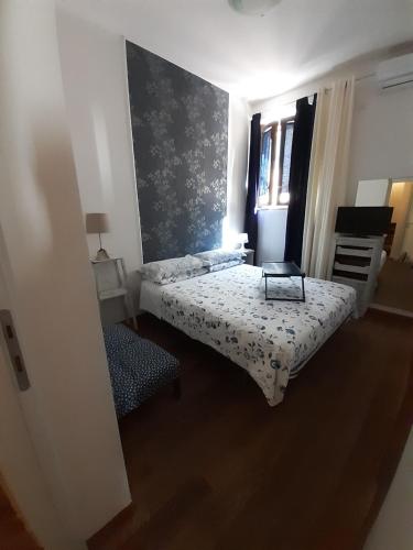 a small bedroom with a bed and a window at B&B La Casa di Alice in Foligno