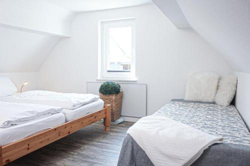 a bedroom with two beds and a window at Bergkrönchen Winterberg - Sauna - 8Beds - outdoor in Winterberg