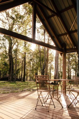 a patio with a table and chairs on a porch at Littlewood Chalet in Margaret River Town