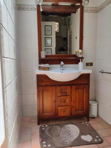 a bathroom with a sink and a mirror at La Casa Di Miri in Foligno