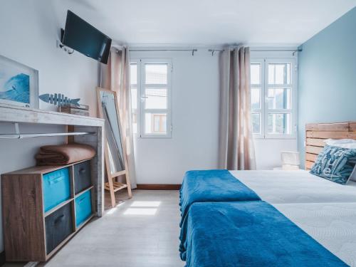 a bedroom with a bed and a tv in it at Nature Madeira Guest House in Porto da Cruz