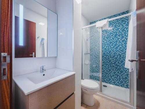 a bathroom with a sink and a toilet and a shower at Nature Madeira Guest House in Porto da Cruz