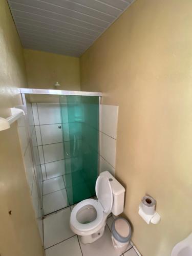 a bathroom with a toilet and a glass shower at Anaconda Amazon Island in Manaus