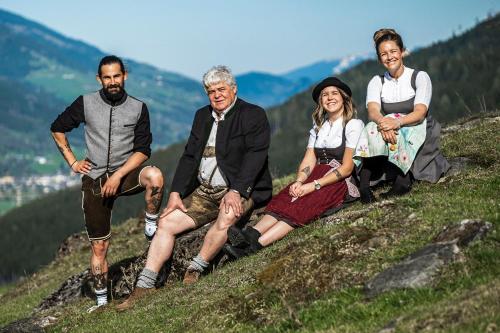 a group of people sitting on top of a hill at Hotel Martini Kaprun - including summercard in Kaprun