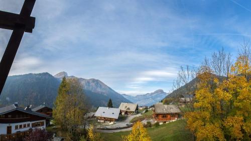 a village in the mountains with trees and houses at Tovassiere - Apt B115 - BO Immobilier in Châtel