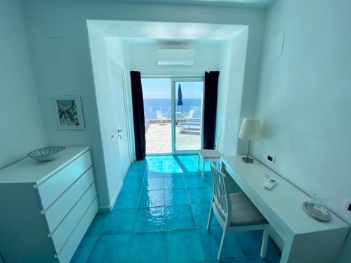 a bathroom with a desk and a view of the ocean at Hotel Casa Sofia in Ischia