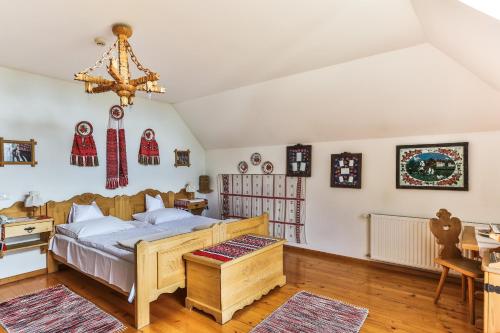 a bedroom with a bed and a desk at Bagolyvár Panzió in Pécs