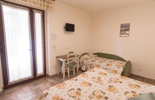 Postel nebo postele na pokoji v ubytování Rosa di Assisi