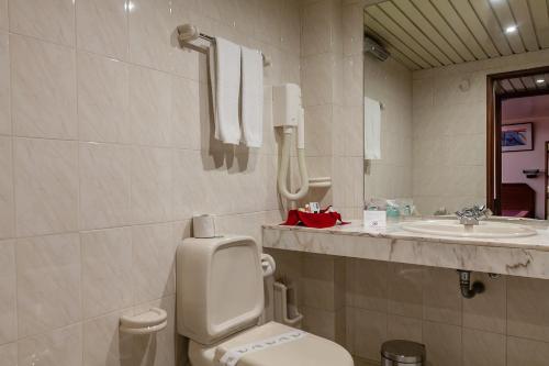 a bathroom with a toilet and a sink at Hotel Nacional in Lisbon