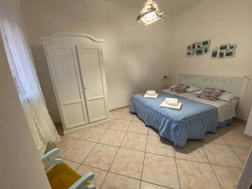 a bedroom with two beds and a cabinet at Lulù Marin Casa Vacanze Praia a Mare in Praia a Mare