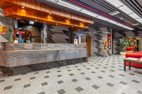 a restaurant lobby with a counter and a red couch at Hotel Nacional in Lisbon