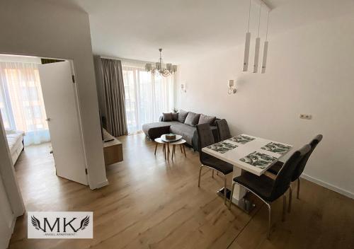 a living room with a couch and a table and chairs at MK Angel Apartment in Krakow