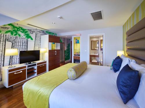 a bedroom with a large bed and a television at Hotel Indigo Edinburgh by IHG in Edinburgh