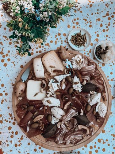 a wooden bowl of food with mushrooms and vegetables at Pr' Kramarju - House in the heart of Kobarid in Kobarid