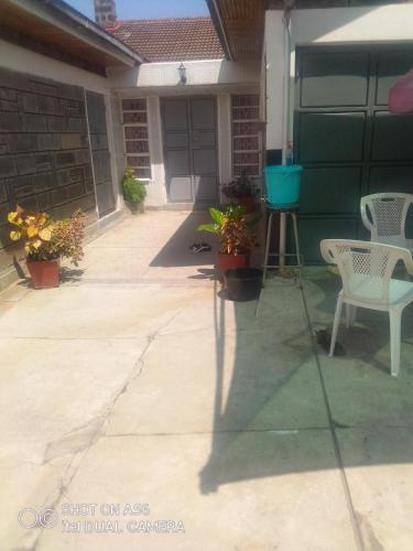 a patio with two chairs and a table at BERNKISH HOMES in Nakuru