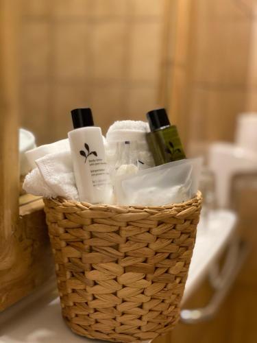 a basket filled with bottles of soap and toiletries at Hotel The New Fox in Affligem