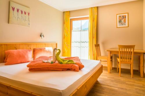 a childs bedroom with a dinosaur toy on a bed at Bio-Bauernhof Obertrattenbachhof in Neukirchen am Großvenediger