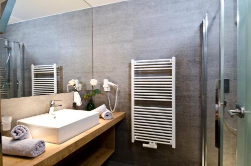a bathroom with a sink and a shower at Wolfs Aparts + More in Ischgl