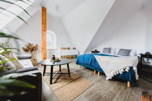 a bedroom with a bed and a table at BOHO HOUSE in Ustrzyki Dolne