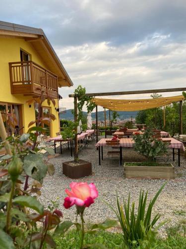 a patio with tables and chairs and a building at Agriturismo La Soglia Del Parco in Ranica