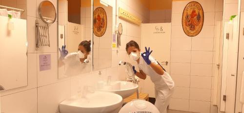 a woman wearing a mask in a bathroom at Santander Central Hostel in Santander