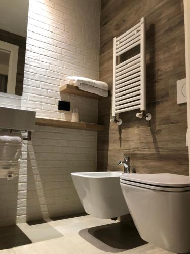 a bathroom with a white toilet and a sink at Hotel Ombra in Riccione
