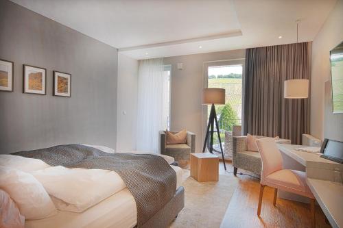 a hotel room with a bed and a desk and a desk at Hotel Restaurant zur Marienburg in Pünderich