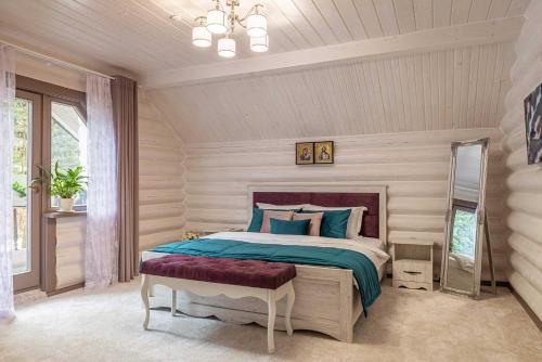 a bedroom with a large bed with blue pillows at Шале "Ведмежий Двір" in Palyanytsya