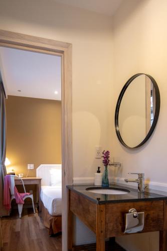 a bathroom with a sink and a mirror at La Em Boutique Villa in Da Lat
