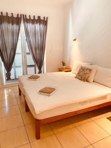 a bedroom with a large bed with two trays on it at Hostal Villa Senese in Paguera