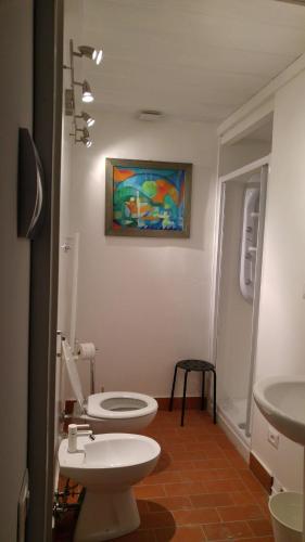 a bathroom with a toilet and a sink at Lucretia House in Florence